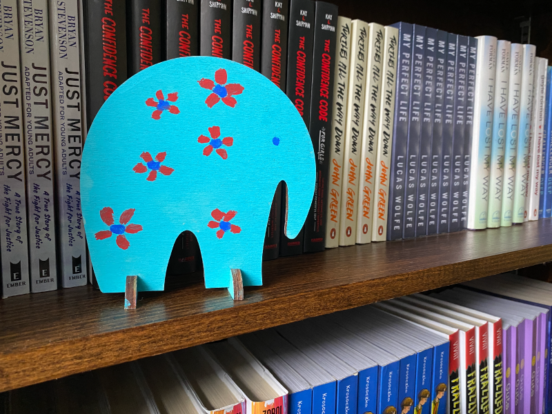 The Mokita Elephant stand on a bookshelf