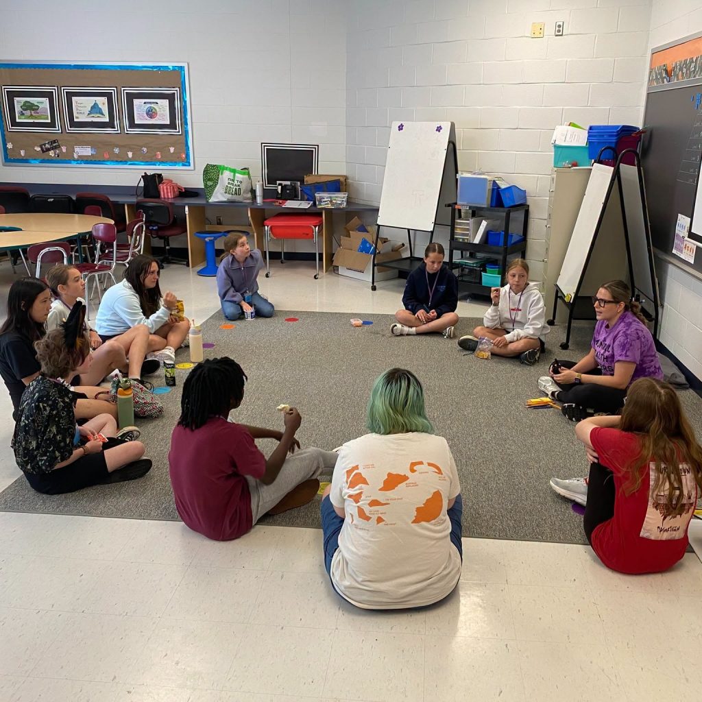 Image of children sitting and talking in a circle